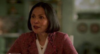 Movie still from “Easter Sunday” (2022), directed by Jay Chandrasekhar – An older woman wearing a pink jacket and white shirt; Close Up shot, Over the shoulder angle