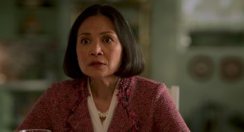 Movie still from “Easter Sunday” (2022), directed by Jay Chandrasekhar – An older woman wearing a pink jacket looking at the camera; Close Up shot, Over the shoulder angle