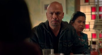Movie still from “Easter Sunday” (2022), directed by Jay Chandrasekhar – A man sitting in front of a woman at a table; Close Up shot, Over the shoulder angle