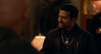 Movie still from “Easter Sunday” (2022), directed by Jay Chandrasekhar – A person wearing a necklace; Close Up shot, Over the shoulder angle