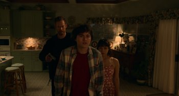 Movie still from “Easter Sunday” (2022), directed by Jay Chandrasekhar – A group of people standing in a living room; Medium shot, Over the shoulder angle