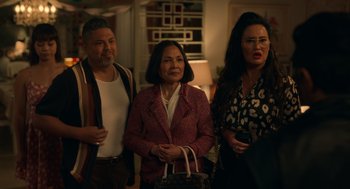 Movie still from “Easter Sunday” (2022), directed by Jay Chandrasekhar – A group of people standing next to each other in a room; Medium shot, Over the shoulder angle