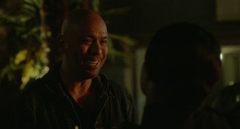 Movie still from “Easter Sunday” (2022), directed by Jay Chandrasekhar – A man with a bald head smiling at a woman; Close Up shot, Over the shoulder angle