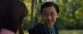 Movie still from “A Dog's Journey” (2019), directed by Gail Mancuso – A young boy wearing glasses and a blue jacket; Close Up shot, Over the shoulder angle