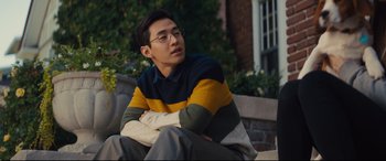 Movie still from “A Dog's Journey” (2019), directed by Gail Mancuso – A man sitting on top of a brick wall; Medium shot, Over the shoulder angle