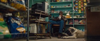 Movie still from “A Dog's Journey” (2019), directed by Gail Mancuso – A man sitting in a chair in front of a television; Wide shot, Low angle