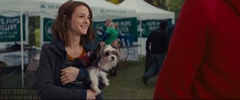 Movie still from “A Dog's Journey” (2019), directed by Gail Mancuso – A woman holding a small dog in her arms; Medium shot, Over the shoulder angle