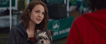 Movie still from “A Dog's Journey” (2019), directed by Gail Mancuso – A woman and a small dog sitting next to each other; Close Up shot, Over the shoulder angle