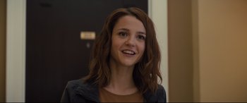 Movie still from “A Dog's Journey” (2019), directed by Gail Mancuso – A woman with brown hair and a brown shirt smiling for the camera; Close Up shot, Over the shoulder angle