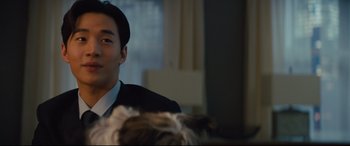 Movie still from “A Dog's Journey” (2019), directed by Gail Mancuso – A person wearing a suit and a hat; Close Up shot, Over the shoulder angle