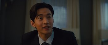 Movie still from “A Dog's Journey” (2019), directed by Gail Mancuso – A man in a suit and tie looking to his left; Close Up shot, Over the shoulder angle