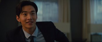 Movie still from “A Dog's Journey” (2019), directed by Gail Mancuso – A man in a suit and tie sitting in an office chair; Close Up shot, Over the shoulder angle