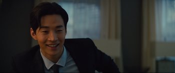 Movie still from “A Dog's Journey” (2019), directed by Gail Mancuso – A man in a suit and tie smiling for the camera; Close Up shot, Over the shoulder angle