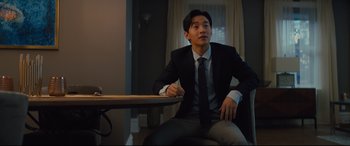 Movie still from “A Dog's Journey” (2019), directed by Gail Mancuso – A man sitting at a table in front of a window; Medium shot, Low angle