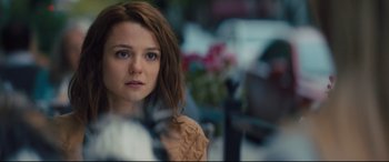 Movie still from “A Dog's Journey” (2019), directed by Gail Mancuso – A young woman with brown hair is looking at the camera; Close Up shot, Over the shoulder angle