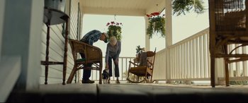 Movie still from “A Dog's Journey” (2019), directed by Gail Mancuso – A man and a woman standing on a porch petting a cat; Wide shot, Low angle