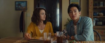 Movie still from “A Dog's Journey” (2019), directed by Gail Mancuso – Two people sitting at a table with a drink; Medium shot, Over the shoulder angle