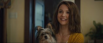Movie still from “A Dog's Journey” (2019), directed by Gail Mancuso – A woman and a dog are smiling for the camera; Close Up shot, Over the shoulder angle