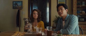 Movie still from “A Dog's Journey” (2019), directed by Gail Mancuso – A group of people sitting at a table with a dog; Medium shot, Over the shoulder angle