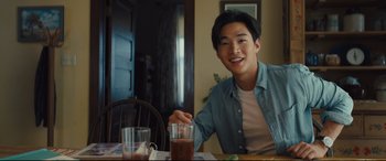 Movie still from “A Dog's Journey” (2019), directed by Gail Mancuso – A man sitting at a table with a glass of water; Medium shot, Over the shoulder angle