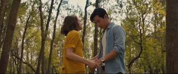 Movie still from “A Dog's Journey” (2019), directed by Gail Mancuso – A man and a woman holding hands in a forest; Medium shot, Over the shoulder angle