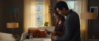 Movie still from “A Dog's Journey” (2019), directed by Gail Mancuso – A man and a pregnant woman looking at an ipad; Medium shot, Over the shoulder angle