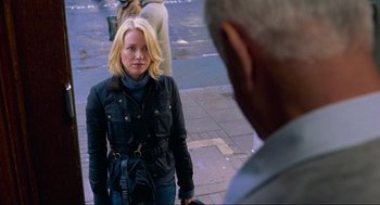 Movie still from “Eastern Promises” (2007), directed by David Cronenberg – A woman standing next to a man on a sidewalk; Medium shot, Over the shoulder angle