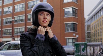 Movie still from “Eastern Promises” (2007), directed by David Cronenberg – A woman wearing a motorcycle helmet while standing on a street; Close Up shot, Over the shoulder angle