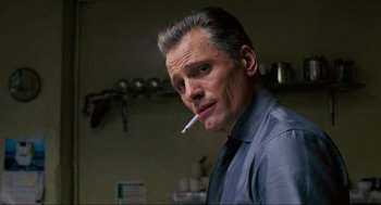 Movie still from “Eastern Promises” (2007), directed by David Cronenberg – A person smoking a cigarette; Close Up shot, Low angle