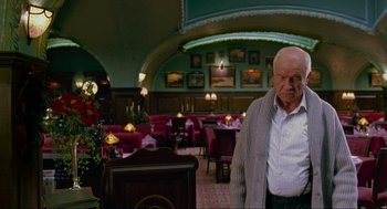 Movie still from “Eastern Promises” (2007), directed by David Cronenberg – An older man standing in front of an empty restaurant; Medium shot, Low angle