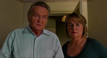 Movie still from “Eastern Promises” (2007), directed by David Cronenberg – An older man and a younger woman standing next to each other; Close Up shot, High angle