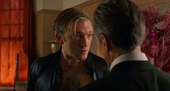 Movie still from “Eastern Promises” (2007), directed by David Cronenberg – A man in a leather jacket looking at another man in a suit in front of a mirror; Close Up shot, Over the shoulder angle