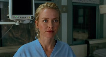 Movie still from “Eastern Promises” (2007), directed by David Cronenberg – A woman wearing a blue shirt in front of a window; Close Up shot, Over the shoulder angle