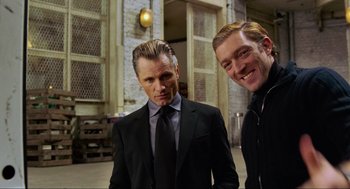Movie still from “Eastern Promises” (2007), directed by David Cronenberg – Two men standing next to each other wearing suits and ties; Medium shot, Low angle