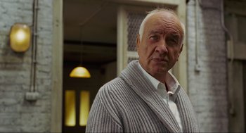 Movie still from “Eastern Promises” (2007), directed by David Cronenberg – An older man wearing a white shirt and a gray sweater; Close Up shot, Low angle