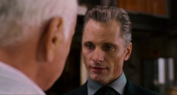 Movie still from “Eastern Promises” (2007), directed by David Cronenberg – A person wearing a suit and tie; Close Up shot, Over the shoulder angle
