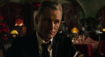 Movie still from “Eastern Promises” (2007), directed by David Cronenberg – A person wearing a suit and tie; Close Up shot, Over the shoulder angle