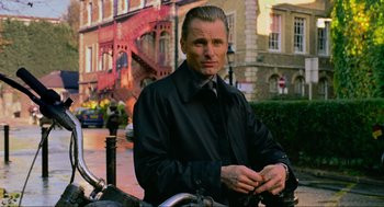 Movie still from “Eastern Promises” (2007), directed by David Cronenberg – A man in a black jacket standing next to a motorcycle; Close Up shot, Low angle