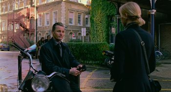 Movie still from “Eastern Promises” (2007), directed by David Cronenberg – A man sitting on the back of a motorcycle; Medium shot, Over the shoulder angle
