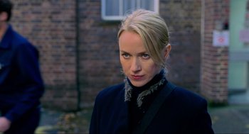 Movie still from “Eastern Promises” (2007), directed by David Cronenberg – A woman with blonde hair wearing a black jacket; Close Up shot, Over the shoulder angle
