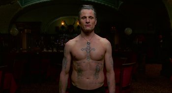 Movie still from “Eastern Promises” (2007), directed by David Cronenberg – A man with a cross tattooed on his chest; Medium shot, Low angle