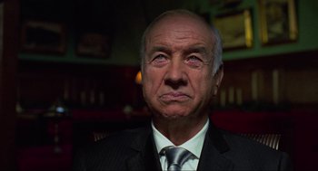 Movie still from “Eastern Promises” (2007), directed by David Cronenberg – An older man wearing a suit and tie; Close Up shot, Low angle