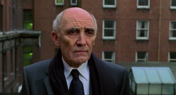 Movie still from “Eastern Promises” (2007), directed by David Cronenberg – An older man wearing a suit and a tie; Close Up shot, Low angle