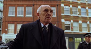 Movie still from “Eastern Promises” (2007), directed by David Cronenberg – An older man wearing a suit and tie; Close Up shot, Low angle