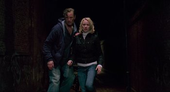 Movie still from “Eastern Promises” (2007), directed by David Cronenberg – A man and a woman are walking together; Medium shot, Low angle