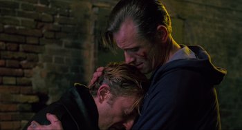 Movie still from “Eastern Promises” (2007), directed by David Cronenberg – A man and a woman embracing each other in a dark room; Close Up shot, Over the shoulder angle