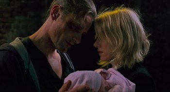 Movie still from “Eastern Promises” (2007), directed by David Cronenberg – A man and a woman holding a newborn baby; Close Up shot, Low angle