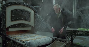 Movie still from “Edward Scissorhands” (1990), directed by Tim Burton – An old man standing in front of an oven; Medium shot, Low angle