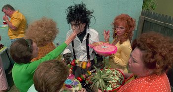 Movie still from “Edward Scissorhands” (1990), directed by Tim Burton – A group of people dressed up in costumes; Medium shot, High angle