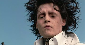 Movie still from “Edward Scissorhands” (1990), directed by Tim Burton – A young man's face , with hair falling off his face; Close Up shot, Low angle